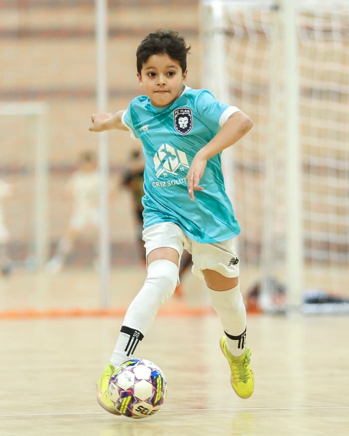 A player in close control driving at goal