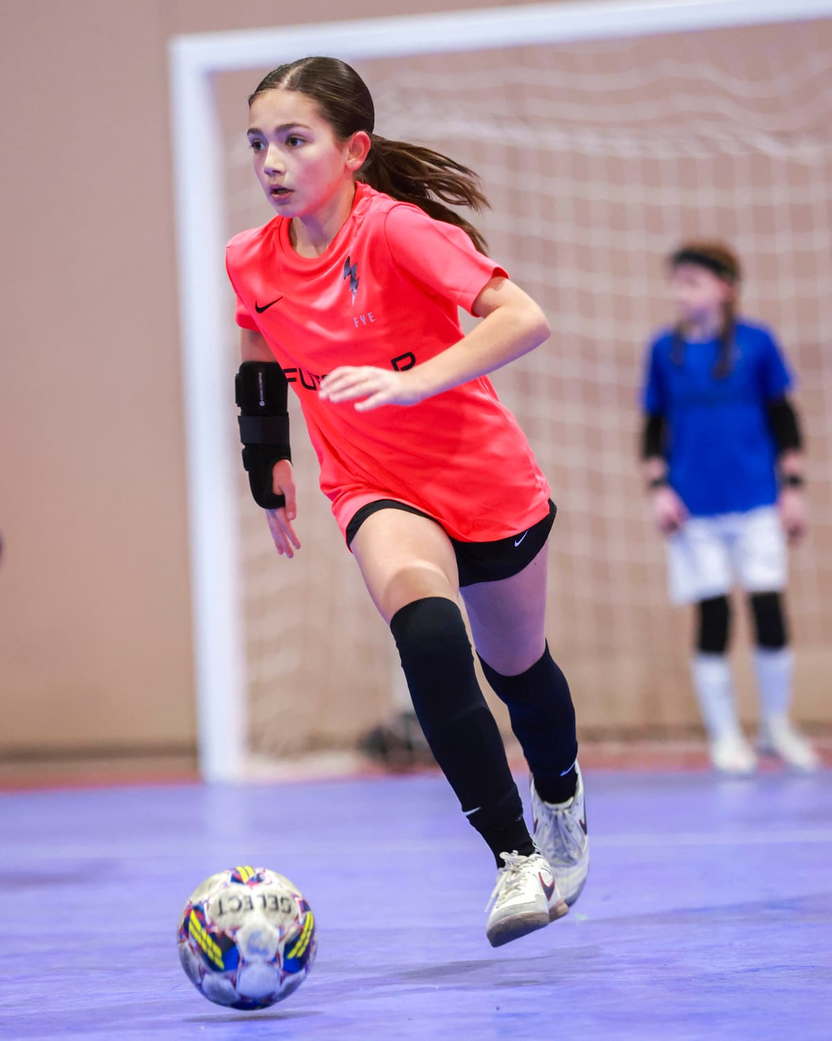 A player drives forward with the ball at pace